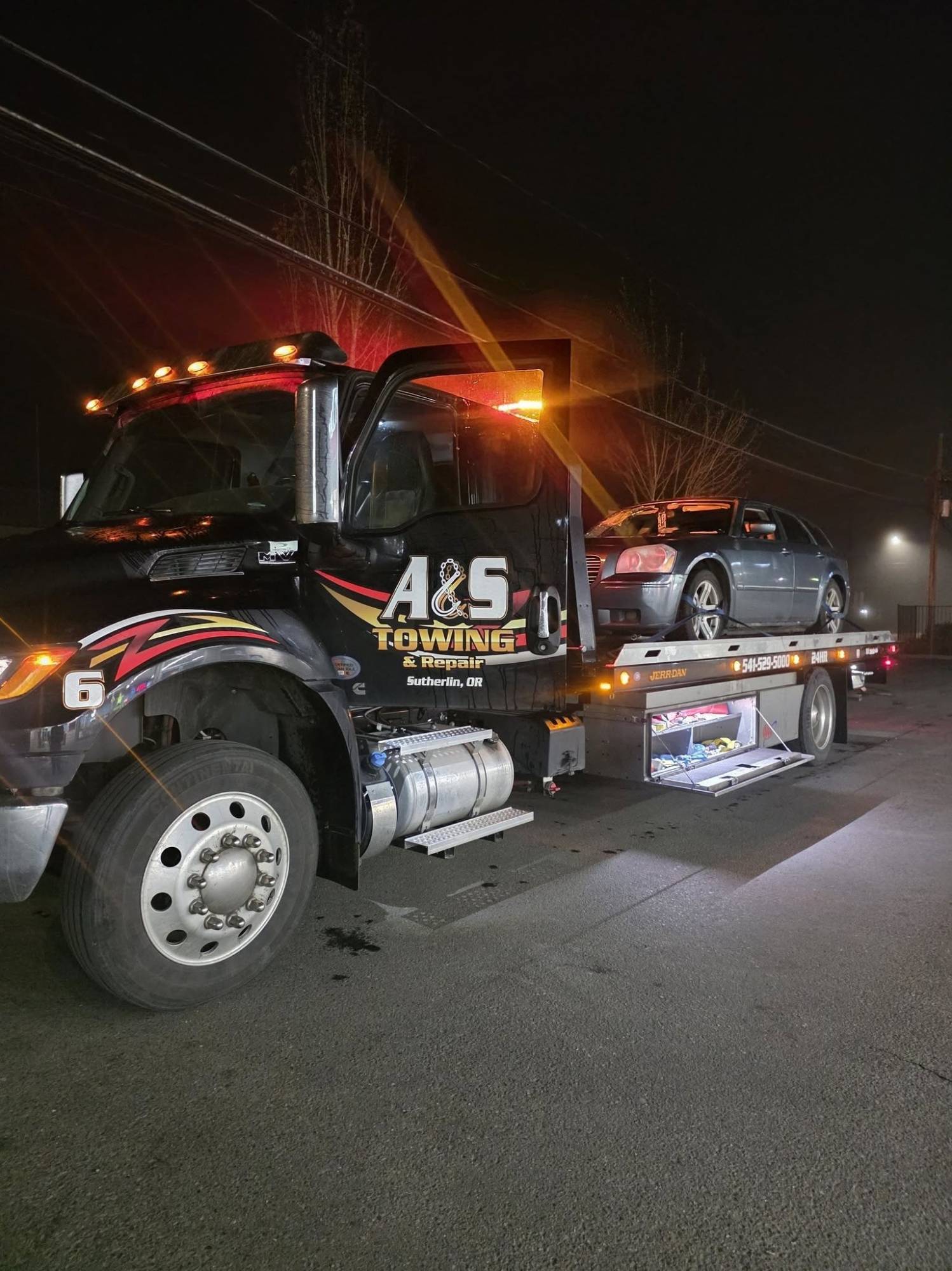 A&S flatbed delivering a car