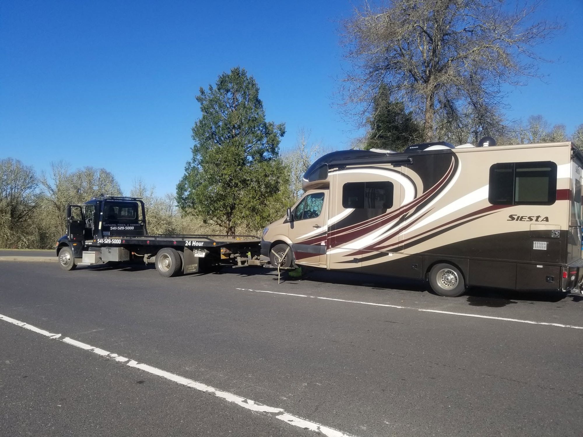 A&S flatbed towing a Siesta RV